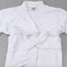 A white Oxford Velour kimono style bath robe with a white belt on a gray surface.