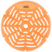 An orange circular Lavex urinal screen with holes in it.
