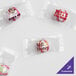 A group of small packages of customizable soft peppermints with clear wrappers.