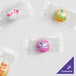 Clear plastic bags filled with customizable chocolate pastel mints with assorted candy shells.