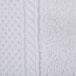 A close up of a white knitted fabric wash cloth with a white border.