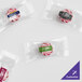 A group of clear packages of red peppermint starlite candies with a customizable label.