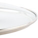 A Lodge tempered glass cover with a metal rim.