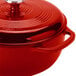 A Lodge Island Spice Red Enameled Cast Iron Dutch Oven with a lid.