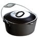A Lodge black cast iron dutch oven with a metal handle.