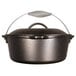 A black Lodge cast iron Dutch oven with a metal handle.