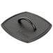 A black square Lodge flat grill press with a handle.