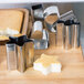 A set of Ateco stainless steel fancy shaped cookie cutters on a table with a star shaped cookie.