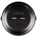 A Lodge black cast iron lid.