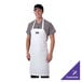 A man wearing a white Chef Revival bib apron.