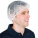 A man wearing a Chef Revival white disposable polypropylene hair net.