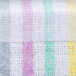 A close-up of a white and pink striped fabric with green stripes.