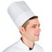 A man wearing a Chef Revival pinstripe chef hat with adhesive closure.
