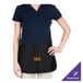 A woman wearing a black Chef Revival waist apron with 3 pockets.