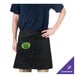 A man wearing a black Chef Revival bistro apron with a green logo on a counter in a professional kitchen.