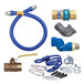 A blue Dormont gas connector kit with fittings, a flexible hose, and a yellow label.