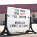 An Aarco white roadside A-Frame sign with stand and letters on a sidewalk.