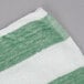 An Oxford green and white striped pool towel.