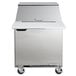 A silver Beverage-Air refrigerator with a lid on wheels.
