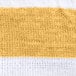 A close up of a white and yellow striped Oxford pool towel.