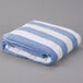 An Oxford blue and white striped pool towel.