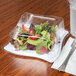 A salad in a Fineline white plastic square plate.