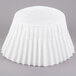 A white paper cupcake liner on a table.