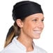 A smiling woman wearing a black Chef Revival bandana.