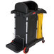 A black Rubbermaid janitor cart with locking cabinets.