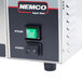 A green square Nemco momentary switch with a black cover.