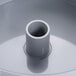 A close-up of a grey container with a white plastic tube inside.