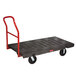 A black Rubbermaid heavy-duty platform truck with a red handle.
