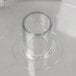 A clear Robot Coupe cutter bowl on a white surface