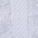 A close up of a white fabric with a dobby border.