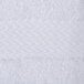 A close up of a white Oxford Regale bath towel with a white dobby border.
