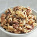 A bowl of Raw Walnut Halves and Pieces on a white table.