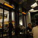 A group of people sitting at tables in a restaurant dining area with Bromic Heating commercial patio heaters.