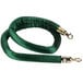 A green velvet rope with brass ends.