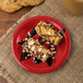 A dessert on a Carlisle red melamine pie plate on a table.