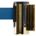 A brass wall-mount stanchion with a blue belt attached to it.