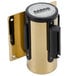 A gold and black metal wall mount with a black and blue cylinder.