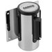 A chrome wall-mount stanchion with a blue retractable belt in a metal cylinder.
