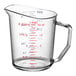A clear Cambro measuring cup with red and blue writing.