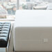 A white rectangular Bargoose Hybrid Zippered bed bug proof mattress encasement on a white mattress.