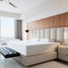 A modern white bedroom with a Bargoose Hybrid zippered bed bug proof king mattress encasement on a white bed.