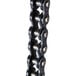 A close-up of a black chain link with two metal balls on it.