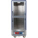 A blue Metro C5 heated holding and proofing cabinet with clear Dutch doors and shelves.