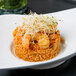 A plate of food with a shrimp on a CAC Bright White Porcelain bowl.