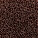 A close-up of a brown unbacked scraper mat with a pile of brown coil.