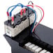 A black Waring control panel module with wires and switches.